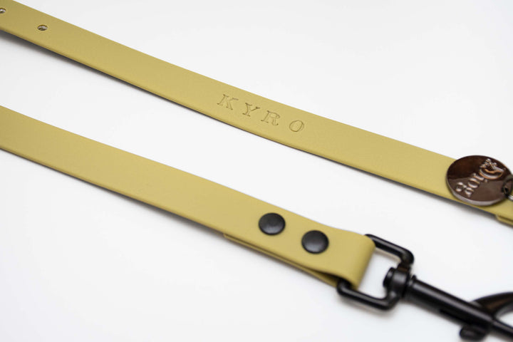 Image of a waterproof leash in a tan color with a black hardware. The text "KYRO" is written on the leash.