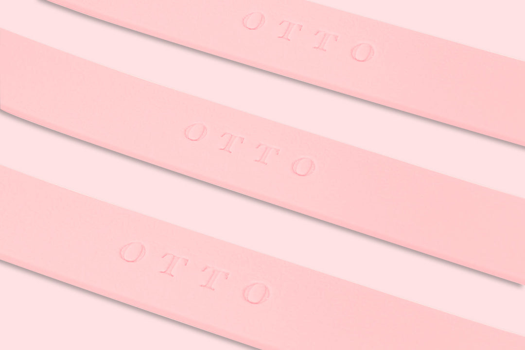 Close-up of pink waterproof collars. The collars have the names embossed on them.