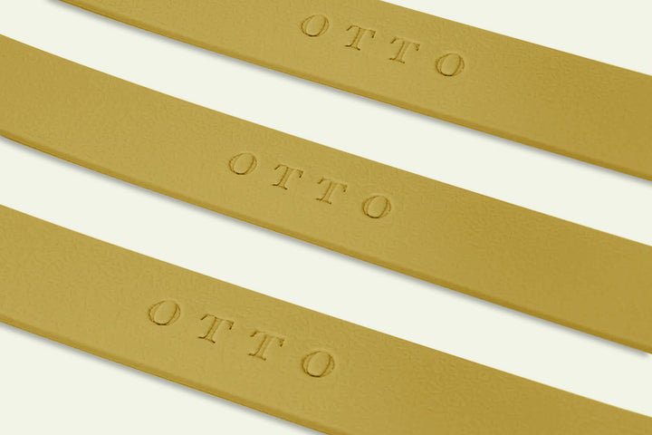 Close-up of tan waterproof collars. The collars have the names embossed on them.