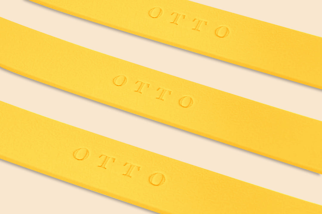 Close-up of yellow waterproof collars. The collars have the names embossed on them.